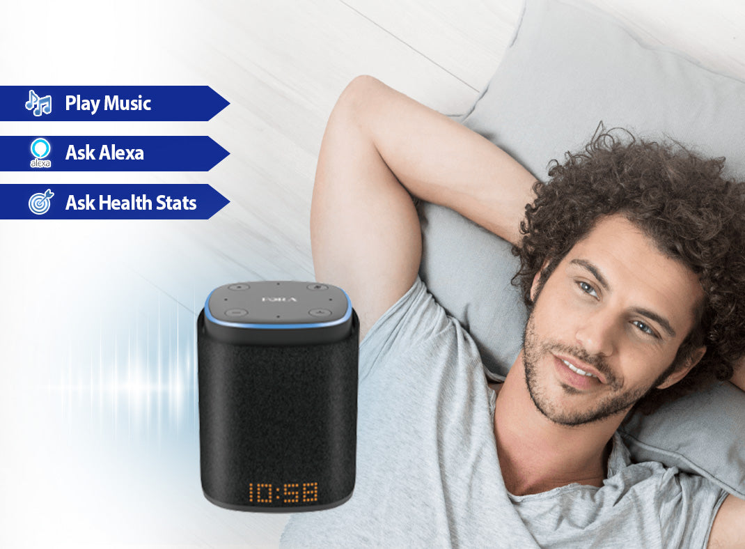 Promotional banner showing a man lying on a couch next to a FORA IntelliSpeaker smart speaker with features listed as Play Music, Ask Alexa, and Ask Health Stats